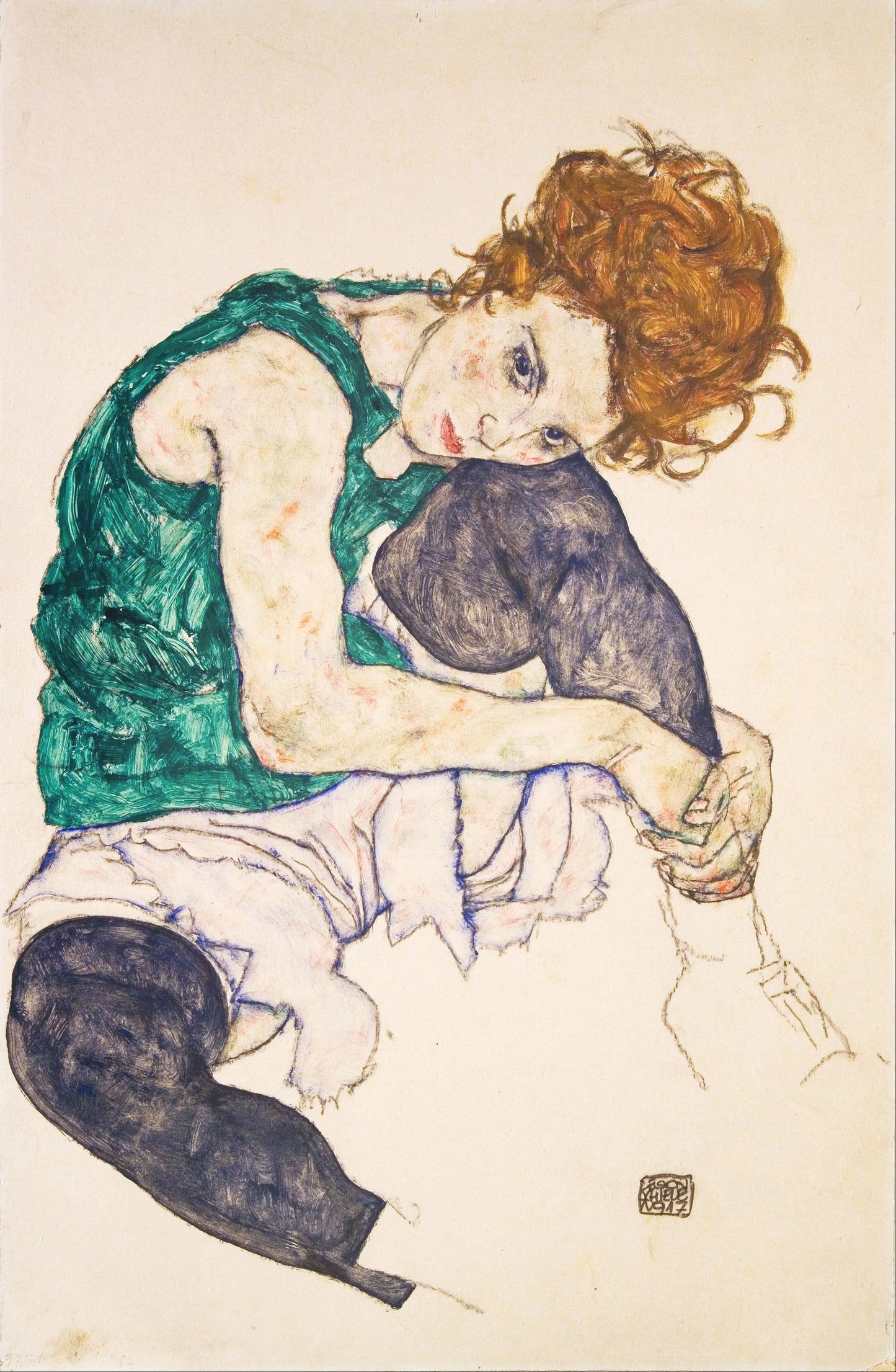 Seated woman with legs drawn up